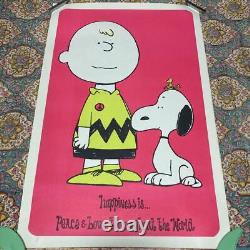 Affiche vintage des années 70 de Charlie Brown et Snoopy avec le symbole de la paix utilisé.