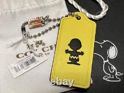 COACH X PEANUTS Porte-clés breloque en cuir avec étiquette suspendue Snoopy Charlie Brown, neuf avec étiquette